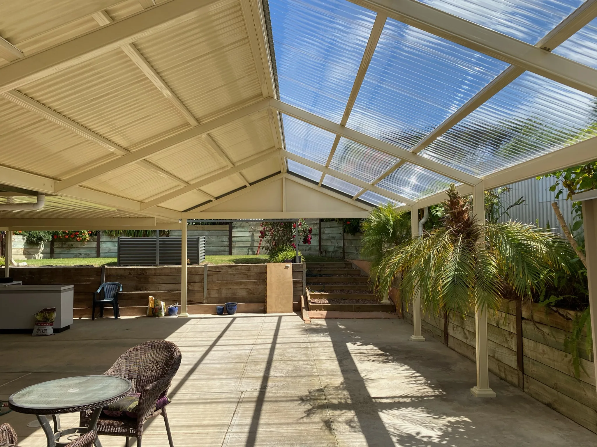 Gabled roof pergola with metal and translucent roofing for a versatile outdoor space